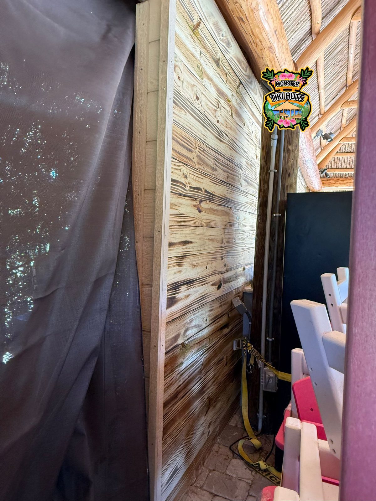 Custom privacy wall beside tiki structure