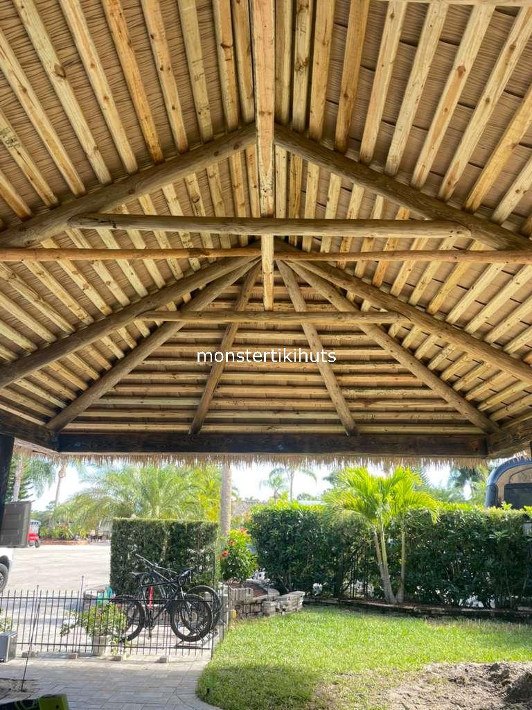 Vaulted synthetic thatch ceiling with horizontal battens