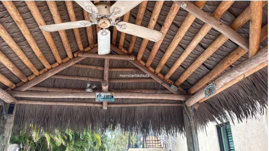 Synthetic thatch interior ceiling with fan and wooden rafters